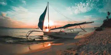 white boat docked on seashore