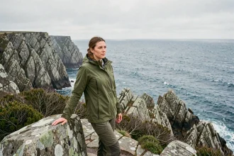 Randonneuse au bord des falaises de la pointe de Kadoran avec vue panoramique sur l'océan Atlantique